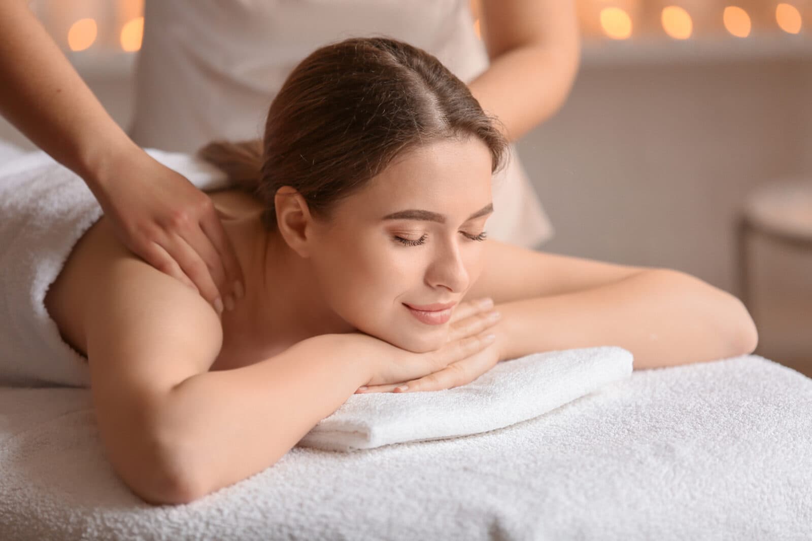 A calming back massage in a warm, candlelit room