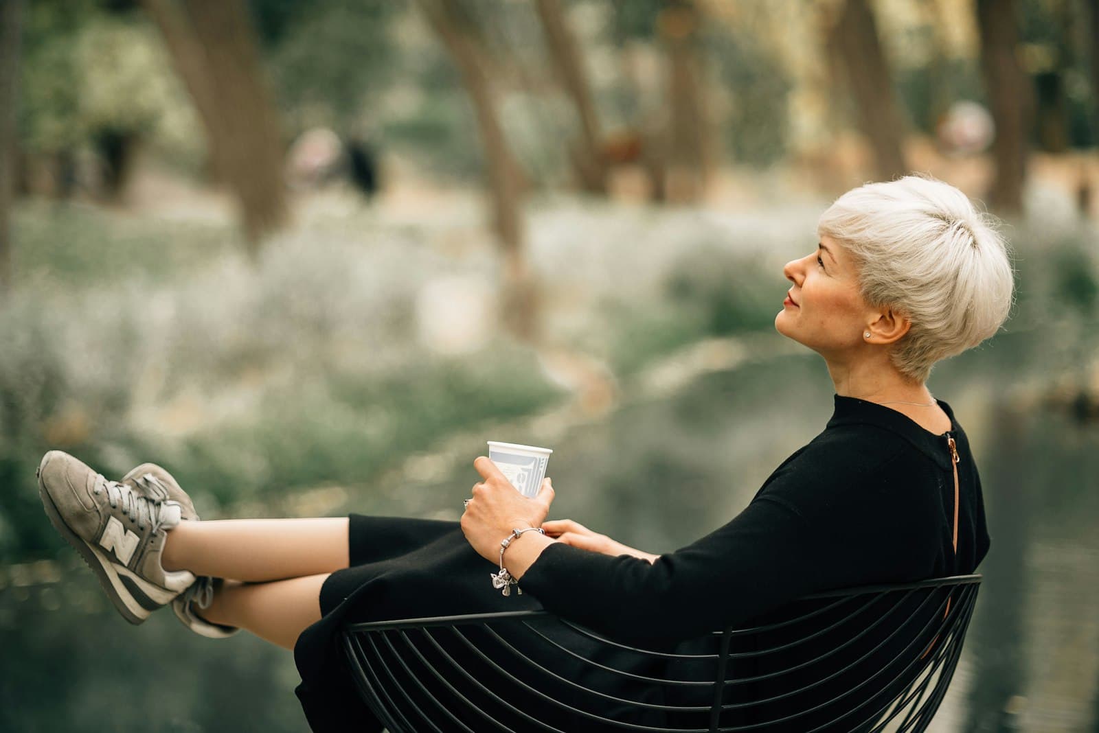 A woman in her fifties resting calmly with her eyes closed in soft light