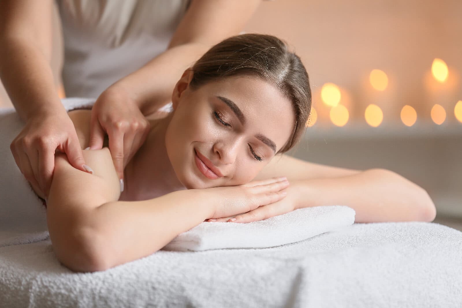 A calming back massage in a warm, candlelit room