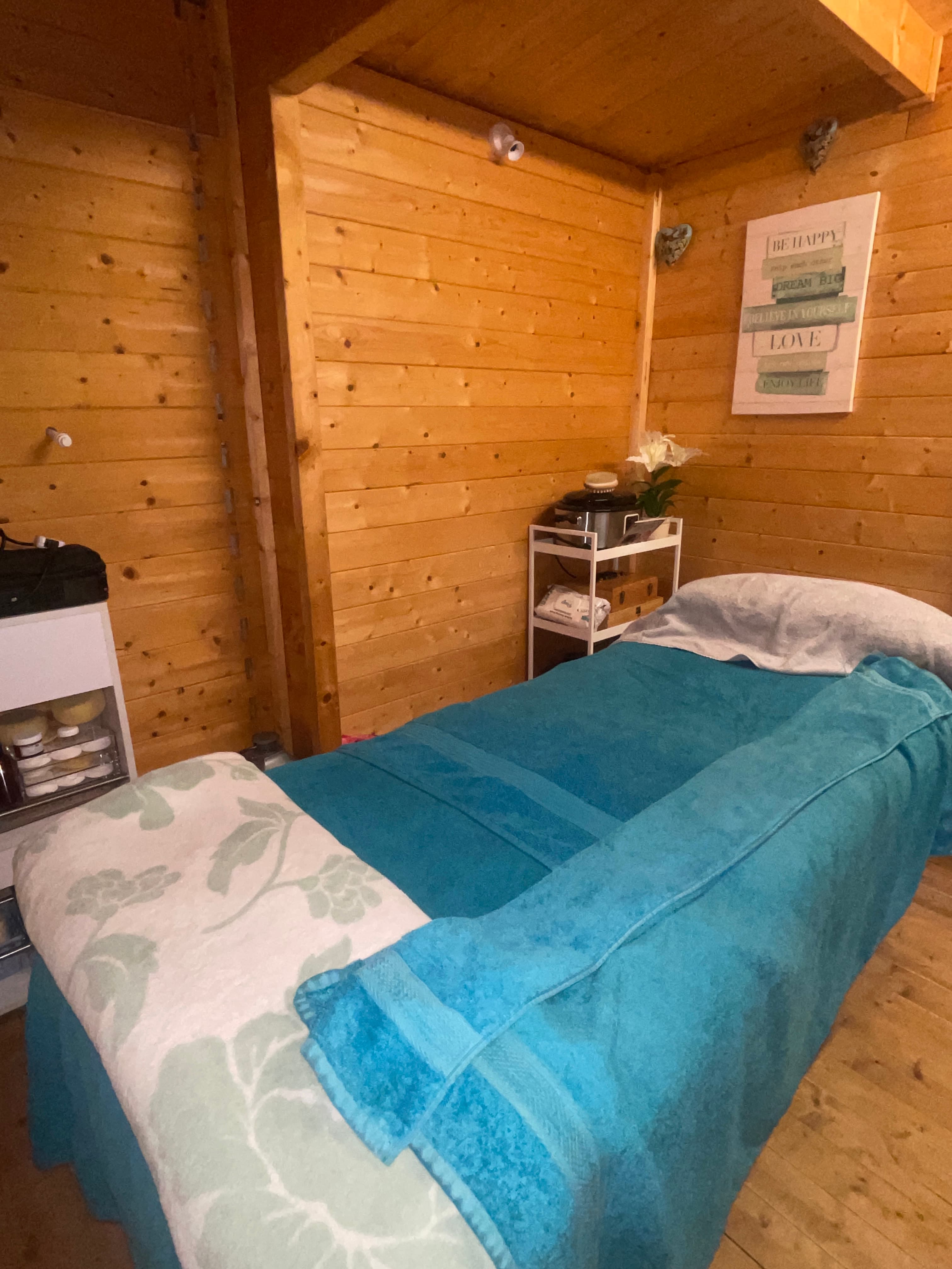 The calm, private treatment room in the log cabin studio